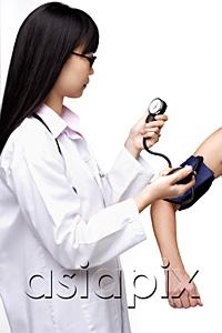 AsiaPix - Female doctor checking blood pressure of patient