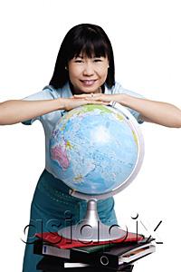 AsiaPix - Woman leaning on globe, smiling