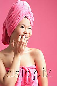 AsiaPix - Woman wrapped in a pink towel, hand over mouth