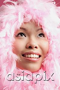 AsiaPix - Woman with pink feathers around her face, looking up