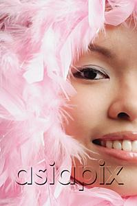 AsiaPix - Woman with pink feathers around her face, cropped image