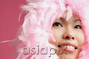 AsiaPix - Woman's face surrounded by pink feathers