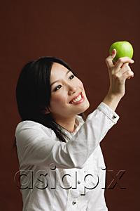 AsiaPix - Woman looking at green apple