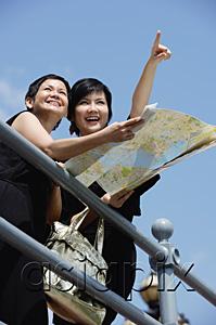 AsiaPix - Two women side by side, one pointing in the distance, the other holding map