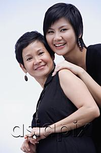 AsiaPix - Mother and adult daughter smiling, looking at camera