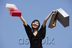 AsiaPix - Woman carrying shopping bags, arms outstretched