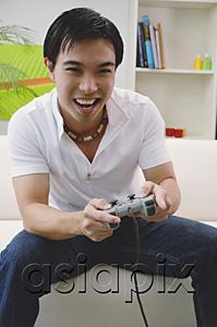 AsiaPix - Man holding video game controller