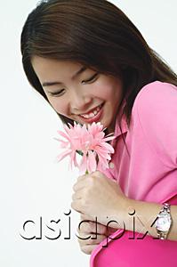 AsiaPix - Woman dressed in pink, holding pink flower