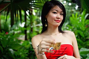AsiaPix - Woman in red dress, holding credit card