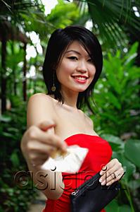 AsiaPix - Woman in red tube top, holding credit card towards camera