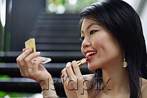 AsiaPix - Woman applying make-up