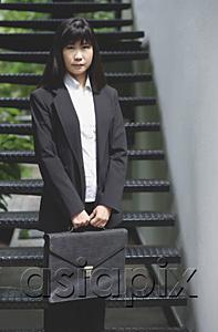 AsiaPix - Businesswoman standing with briefcase