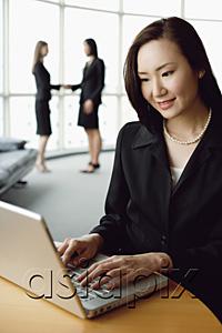 AsiaPix - Portrait of businesswoman using laptop