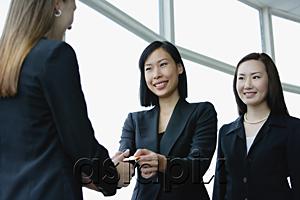 AsiaPix - Three businesswomen exchanging business cards