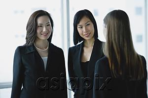 AsiaPix - Three businesswomen, talking