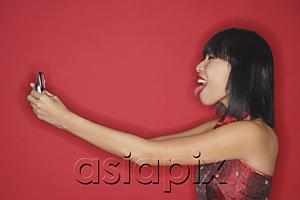 AsiaPix - Woman holding mobile phone, sticking tongue out
