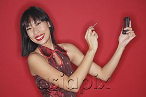 AsiaPix - Woman against red background, holding PDA, smiling at camera