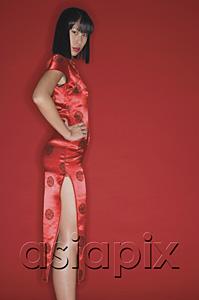 AsiaPix - Woman wearing cheongsam and high heels, hand on hip, looking at camera