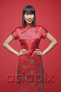 AsiaPix - Woman in cheongsam, hands on hip, smiling at camera