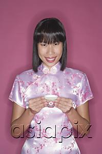 AsiaPix - Woman in pink cheongsam, with Chinese tea cup, portrait