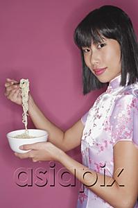 AsiaPix - Woman holding bowl of noodles and chopsticks