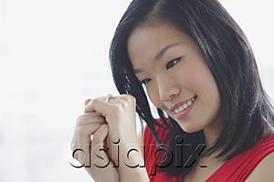 AsiaPix - Woman looking at ring on her finger
