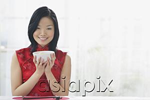 AsiaPix - Woman holding bowl of rice