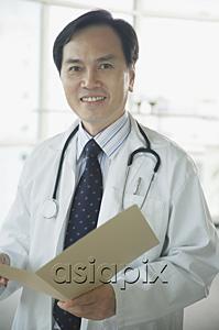 AsiaPix - Doctor smiling at camera, holding folder