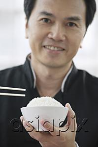 AsiaPix - Man with bowl of rice and chopsticks