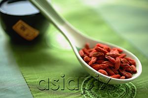 AsiaPix - Dried berries in ceramic spoon, still life