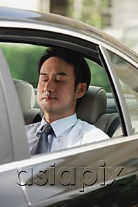 AsiaPix - Businessman sitting in car, eyes closed