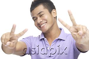 AsiaPix - Man smiling, making peace hand sign