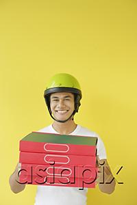AsiaPix - Pizza delivery person carrying a stack of pizza boxes