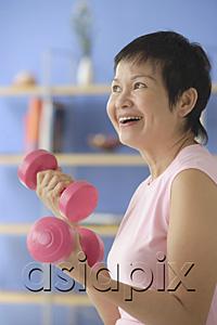 AsiaPix - Woman at home, using dumbbells