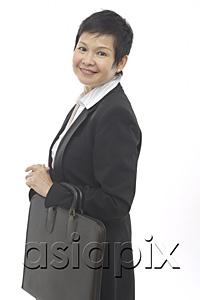 AsiaPix - Mature businesswoman, carrying briefcase, smiling at camera