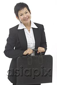 AsiaPix - Mature businesswoman with briefcase, smiling at camera