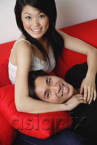AsiaPix - Couple smiling at camera, man lying on woman's lap