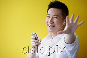 AsiaPix - Man listening to MP3 Player, hand reaching towards camera
