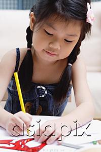 AsiaPix - Young girl drawing with coloured pencils