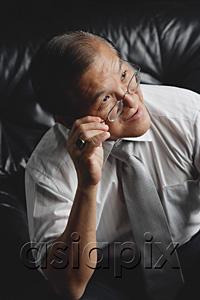 AsiaPix - Senior man adjusting glasses