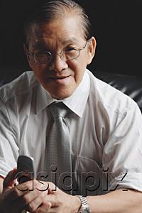 AsiaPix - Senior businessman holding mobile phone