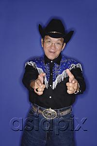 AsiaPix - Senior man dressed in cowboy attire, pointing fingers at camera