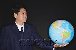 AsiaPix - Businessman holding globe