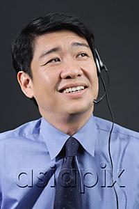 AsiaPix - Businessman using hands free device