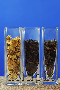 AsiaPix - Row of three glass containers with tea leaves
