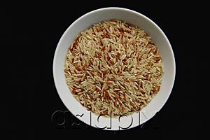AsiaPix - Still life, uncooked rice in a bowl, high angle view