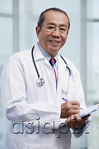 AsiaPix - Doctor writing on medical chart, looking at camera