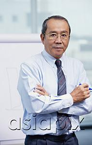 AsiaPix - Businessman standing in front of flipchart, arms crossed
