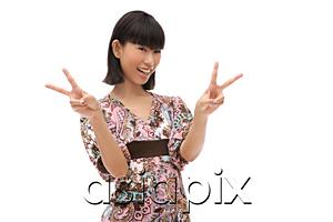 AsiaPix - Young woman making peace sign with fingers