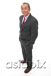 AsiaPix - Businessman standing with hands in pocket